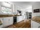 Spacious kitchen with modern appliances, granite counters, hardwood floors, and ample cabinet space at 128 Wellington Rd, Indianapolis, IN 46260