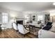 Sun-lit living room with hardwood floors, fireplace, and custom built-in bookshelves at 128 Wellington Rd, Indianapolis, IN 46260