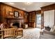 Inviting living room with wood paneling, fireplace, built-in cabinets, and access to the outdoors at 128 Wellington Rd, Indianapolis, IN 46260