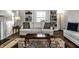 Cozy living room featuring a comfortable sofa, stylish rug, and custom shelving at 128 Wellington Rd, Indianapolis, IN 46260