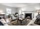 Elegant living room with a fireplace, hardwood floors, and lots of natural light at 128 Wellington Rd, Indianapolis, IN 46260