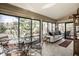 Bright sunroom with panoramic views, stylish furniture, and lots of natural light at 128 Wellington Rd, Indianapolis, IN 46260