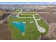 Aerial shot showcasing a residential community with homes, green spaces, and a pond at 15994 Meadow Frost Ct, Fishers, IN 46037