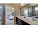 Spa-like bathroom with double sinks, large mirror, and a view of the bedroom at 15994 Meadow Frost Ct, Fishers, IN 46037