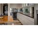 Butlers pantry with wine cooler, granite countertops, and ample cabinet space at 15994 Meadow Frost Ct, Fishers, IN 46037
