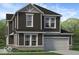 Two-story home with gray siding, brick accents, and a two-car garage at 15994 Meadow Frost Ct, Fishers, IN 46037