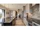 Modern kitchen with large island, stainless steel appliances and hardwood floors at 15994 Meadow Frost Ct, Fishers, IN 46037
