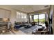 Open living room with kitchen, sliding glass doors, and modern furniture at 15994 Meadow Frost Ct, Fishers, IN 46037