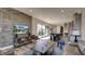 Living room features a stone wall, large TV, and open floor plan at 15994 Meadow Frost Ct, Fishers, IN 46037