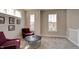 Bright sitting area with two armchairs, a coffee table, and large windows at 15994 Meadow Frost Ct, Fishers, IN 46037