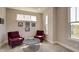 Cozy sitting area with two armchairs, a coffee table, and plenty of natural light at 15994 Meadow Frost Ct, Fishers, IN 46037