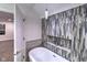 Modern bathtub with stylish faucet and accent tiles adjacent to the bedroom at 1753 Skyline Dr, Greenwood, IN 46143