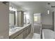 Bright bathroom featuring a double sink vanity, tile flooring, and modern lighting fixtures at 1753 Skyline Dr, Greenwood, IN 46143