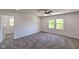 Bright bedroom featuring neutral carpet, a ceiling fan, and double windows with wooded views at 1753 Skyline Dr, Greenwood, IN 46143