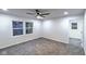 A carpeted bedroom with a ceiling fan, neutral colors and large windows providing natural light at 1753 Skyline Dr, Greenwood, IN 46143