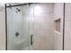 Glass shower with a built-in niche and tiled walls exemplifies modern bathroom design at 1753 Skyline Dr, Greenwood, IN 46143