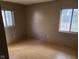 Simple bedroom with hardwood floors and two windows at 1908 Edgemont Way, Anderson, IN 46011