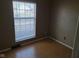 Bright bedroom with hardwood floors and large window at 1908 Edgemont Way, Anderson, IN 46011