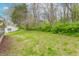 A grassy yard featuring an adjacent garage and sunroom attached to the home at 310 Green St, Plainfield, IN 46168