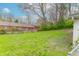 Grassy backyard area adjacent to a red building at 310 Green St, Plainfield, IN 46168
