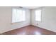 Bright bedroom featuring two windows, hardwood floors, and neutral walls for a calming atmosphere at 310 Green St, Plainfield, IN 46168