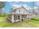Two story home featuring a sunroom, back porch, and backyard at 310 Green St, Plainfield, IN 46168