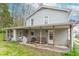 Charming two-story home featuring a covered porch with seating, perfect for enjoying the outdoors at 310 Green St, Plainfield, IN 46168