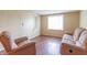 Cozy sitting area features hardwood floors, large windows, a comfortable recliner, and a plush couch at 310 Green St, Plainfield, IN 46168