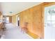 Charming sunroom featuring wood paneling, neutral carpet, and multiple doors and windows offering great natural light at 310 Green St, Plainfield, IN 46168