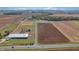 Aerial shot shows equestrian farm with large barn, pastures, and riding ring at 3101 E State Road 47, Lebanon, IN 46052