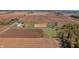 Aerial shot of farm with fields, horse riding area, barn, and wooded border at 3101 E State Road 47, Lebanon, IN 46052
