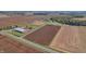 Aerial view showcases farm with a barn, fields, and gravel riding circle at 3101 E State Road 47, Lebanon, IN 46052