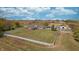 Sprawling property featuring a spacious lawn, fenced perimeter, and functional outbuildings at 3101 E State Road 47, Lebanon, IN 46052