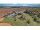 Estate aerial showing farmhouse, white fences, garage, and lush green lawns at 3101 E State Road 47, Lebanon, IN 46052