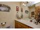 Bathroom with textured walls, oak cabinets, and a white countertop with drop in sink at 3101 E State Road 47, Lebanon, IN 46052