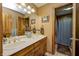 Well-lit bathroom featuring double sinks, vanity, mirrors, and a shower with a curtain at 3101 E State Road 47, Lebanon, IN 46052