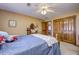 Inviting bedroom featuring carpet, ceiling fan, closet, and warm natural light at 3101 E State Road 47, Lebanon, IN 46052