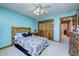 Bright bedroom featuring wood bed frame, soft carpet, ceiling fan, and wooden closet doors at 3101 E State Road 47, Lebanon, IN 46052