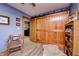 Bedroom with wood accent wall, decorative sliding door, and wood laminate flooring at 3101 E State Road 47, Lebanon, IN 46052
