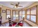 Bright breakfast nook with a rustic table, wood floors, and a view from the many windows at 3101 E State Road 47, Lebanon, IN 46052