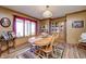 Charming dining room with wood table and chairs, natural light, and a decorative china cabinet at 3101 E State Road 47, Lebanon, IN 46052