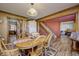 Comfortable dining area adjacent to staircase, featuring hardwood floors, soft lighting, and classic decor at 3101 E State Road 47, Lebanon, IN 46052