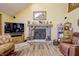 Cozy fireplace with stone surround in a living room with ample seating and natural light at 3101 E State Road 47, Lebanon, IN 46052