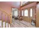 Home foyer boasting a wooden door, hardwood floors, and staircase leading to the upper level at 3101 E State Road 47, Lebanon, IN 46052