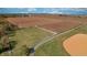 Vast agricultural land featuring a fenced area, bordered by lush greenery and a well-maintained road at 3101 E State Road 47, Lebanon, IN 46052