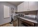 Laundry room featuring front load washer/dryer and white cabinets for storage at 3101 E State Road 47, Lebanon, IN 46052