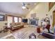 Bright living room with a vaulted ceiling, fireplace, and expansive windows at 3101 E State Road 47, Lebanon, IN 46052