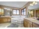 Well-lit main bathroom with double vanity, tub, and decorative tile accents at 3101 E State Road 47, Lebanon, IN 46052
