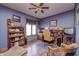 Home office with wood flooring, blue walls, ceiling fan, and a large window at 3101 E State Road 47, Lebanon, IN 46052