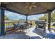 Outdoor gazebo featuring wicker seating, ceiling fan, and BBQ grill, perfect for outdoor entertaining and countryside views at 3101 E State Road 47, Lebanon, IN 46052